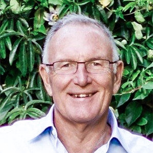 Michael Withey, in front of a wall of plants